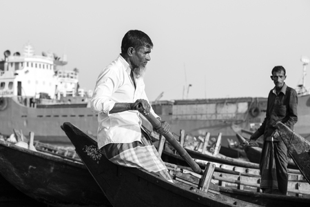 Dhaka, Bangladesh, February 24 2017: Close-up view of a rower in a taxi boat from the perspective of the passenger on the Buriganga River in Dhaka Bangladeshのeditorial素材