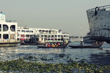 Dhaka, Bangladesh, February 24 2017: People and cargo ships at Sadarghat Terminal on Buriganga River...