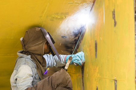 Dhaka, Bangladesh, February 24 2017: Welder on a ship dock on Dhaka Bangladesh welding together two...