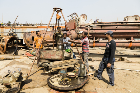 Dhaka, Bangladesh, February 24 2017: Workers at a Dhaka shipyard replace the transmission axle of a shipのeditorial素材