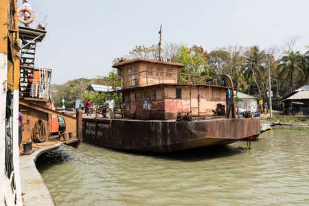 Hularhat, Bangladesh, February 27 2017: The Rocket - an ancient paddle steamer lays off the pier at Hularatのeditorial素材