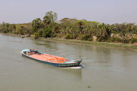 Morrelganj, Bangladesh, February 27 2017: Overloaded cargo ship is driving on a river in Bangladeshのeditorial素材