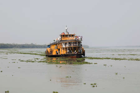 Hularhat, Bangladesh, February 27 2017: The Rocket - an ancient paddle steamer heads to Hularat pier...