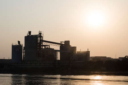 Khulna, Bangladesh, March 1 2017: Industrial plant for cement production on a river bank in...