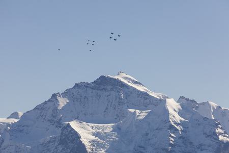 The Swiss Air Force flies a display over the Alps in the Bernese Oberlandの写真素材