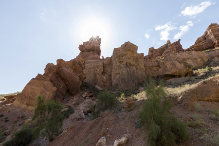 Views within the Charyn Canyon to the reddish sandstone cliffs. The canyon is also called valley of...