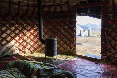 Interior shot of a traditional yurt with stove at Song Kul lake in Kyrgyzstanの写真素材