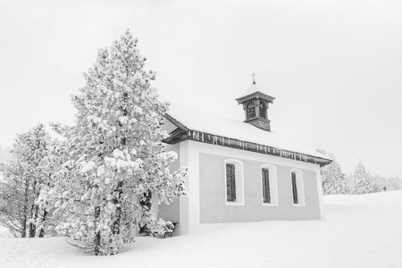High-key winter landscape with a chapel in the foothills of Switzerlandの写真素材