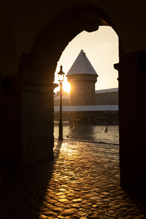 Lucerne, Switzerland, February 4, 2019: Lucerne with snow covered wooden bridge called chapel bridge and water tower with reuss river on a wonderful winter morningのeditorial素材