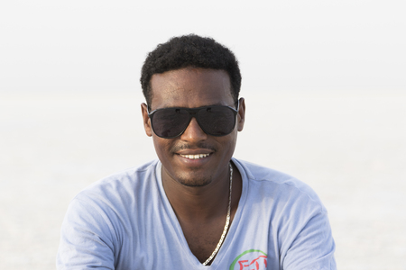 Danakil, Ethiopia, January 22 2015: A handsome young Ethiopian posing with sunglasses in the Danakil desertのeditorial素材