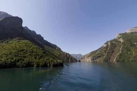 Beautiful landscape with mountains and green forests on a boat trip on the Komani lake in the dinaric alps of Albaniaの写真素材