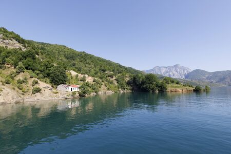 Beautiful landscape with mountains and green forests on a boat trip on the Komani lake in the dinaric alps of Albaniaの写真素材