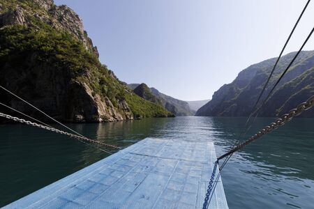 Beautiful landscape with mountains and green forests on a boat trip on the Komani lake in the dinaric alps of Albaniaの写真素材
