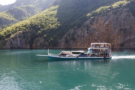 Koman, Albania, July 7 2019: A car and passenger ferry departs in Koman, Komani lake, a 35km long reservoir in the dinaric alpsのeditorial素材