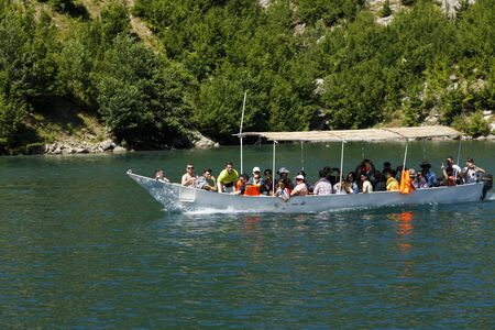 Koman, Albania, July 7 2019: An oncoming tourist boat on the Komani lake in the dinaric alps of Albaniaのeditorial素材