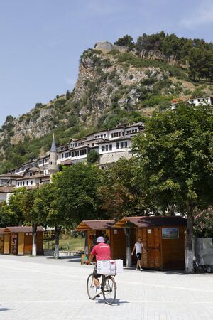 Berat, Albania, July 9 2019: Pedestrian area with park on a summer day in Berat. In the background the old town.のeditorial素材