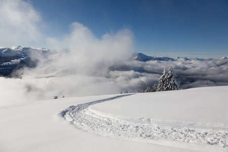 Hiking trail on the Rotenflue in the beautiful winter landscape in Central Switzerland