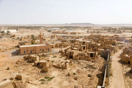 View of the small village Raghba with the abandoned mud houses in the middle of the desert in Saudi...
