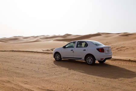 Riyadh, Saudi Arabia, February 16 2020: Typical gravel road with a white car in Saudi Arabia that leads through the desert.のeditorial素材