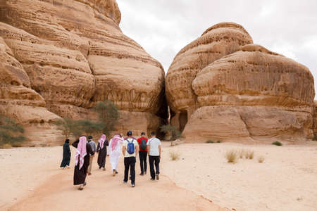 Al Ula, Saudi Arabia, February 19 2020: Tourists run to the entrance of the Siq Jabal Ithlib in Al Ula, KSAのeditorial素材