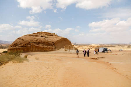 Al Ula, Saudi Arabia, February 19 2020: Parking lot for the rock formation to the Siq Jabal Ithlib in Al Ula, Saudi Arabia. Tour Bus is waiting for tourists.のeditorial素材