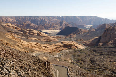 Winding road near Al Ula, which leads up through a dry valley to a viewpoint, Saudi Arabiaの写真素材