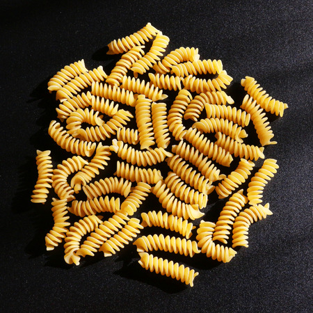 Italian pasta, still life on black background