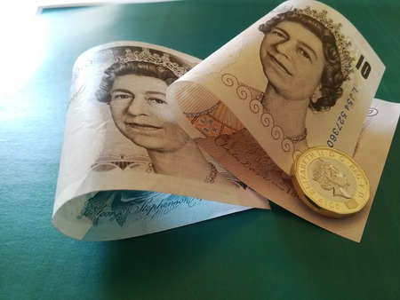 One british pound, new type 2017, with UK banknotes
