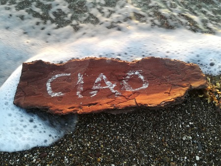 Written CIAO is a wood bark on the beachの写真素材