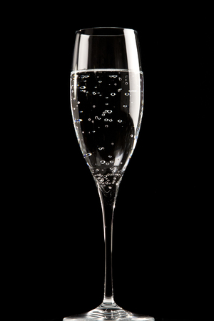 Flute glass on black background, still lifeの写真素材