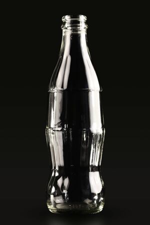 Coca Cola glass bottle withouth brand logo on the black background, editorialのeditorial素材