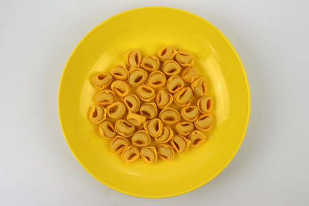 Plate of handmade tortellini ready for cooking, traditional cuisine, italyの写真素材