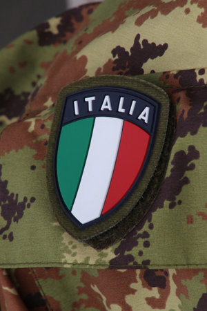 Shield symbol of the Italian flag on military uniform background, Italyの写真素材