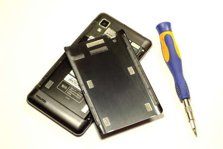 Phone repair on white background, screwdriver, tweezers