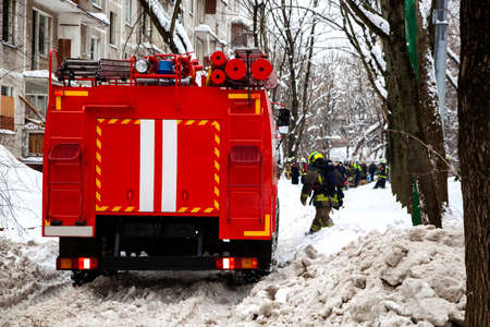 Three firefighters extinguish a fire in an apartment house