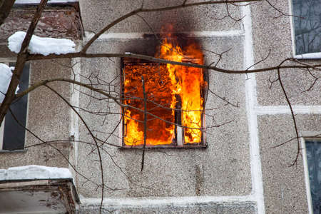Three firefighters extinguish a fire in an apartment house