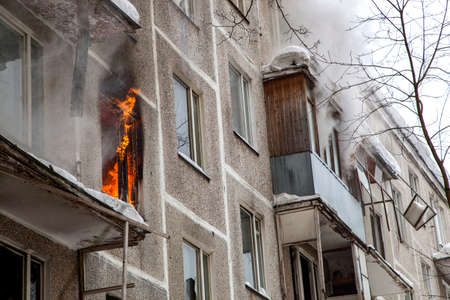 Three firefighters extinguish a fire in an apartment houseの写真素材