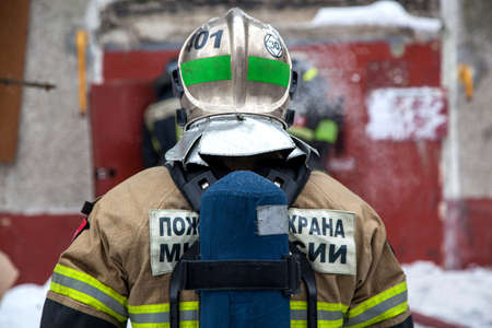 Three firefighters extinguish a fire in an apartment house