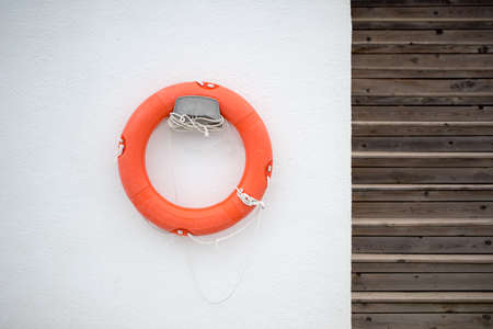 Lifebuoy on a white wall photo for youの写真素材
