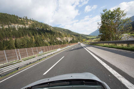 Road, green meadows, blue sky photo for youの写真素材