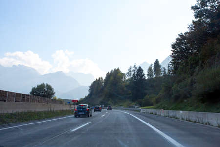 Road, green meadows, blue sky photo for youの写真素材