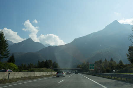 Road, green meadows, blue sky photo for youの写真素材