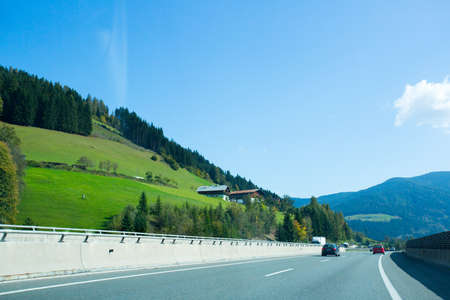 Road, green meadows, blue sky photo for youの写真素材