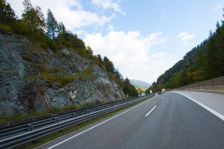 Road, green meadows, blue sky photo for youの写真素材
