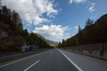 Road, green meadows, blue sky photo for youの写真素材