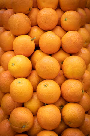 Primeur fruits and vegetables. Detail of mixed pears and oranges at a greengrocer