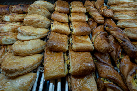 Artisan baker and pastry chef. Detail of apple turnover pastries in a bakeryの写真素材