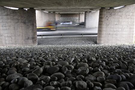 A picture taken from under a bridge by the highway. Cars are driving, and are blurry frome motion. Picture taken on road E6 towards Oslo, Norwayの写真素材