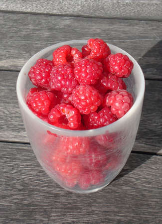 A Glass of Fresh Raspberry on Wooden Table