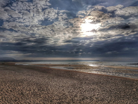 Light mood on the coast of Galicia in Spain, spacious bay with an unusual skyの写真素材